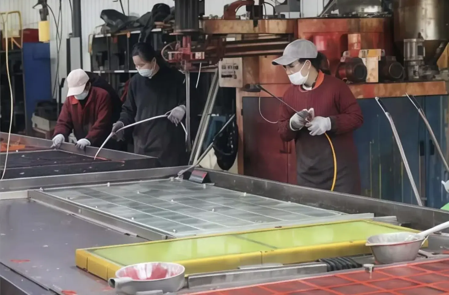 Worker finishing polyurethane screen panels in the workshop
