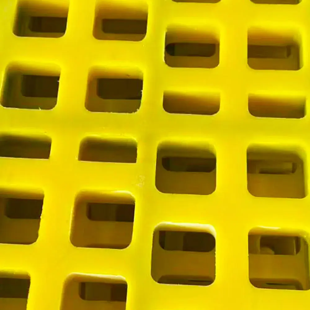 Close view of square openings in a yellow polyurethane panel.
