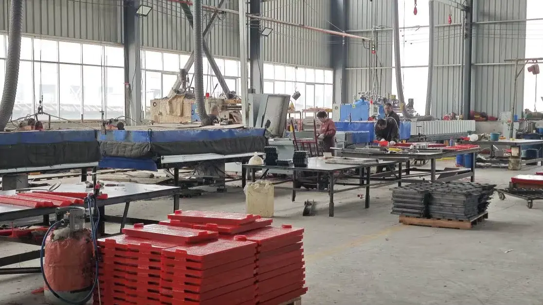 Screen media workshop floor with equipment and stacked panels